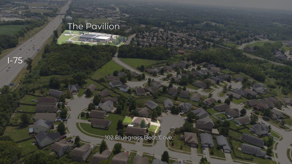 Drone image showing a home and it's location in relation to a swimming pool