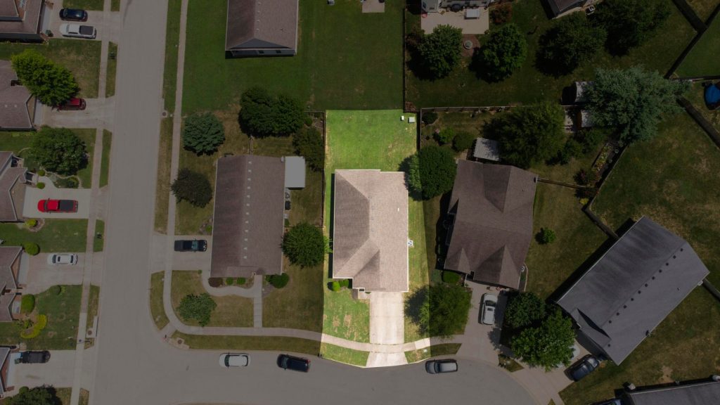 Drone photo of a home in a subdivision where the home is highlighted to show property. 